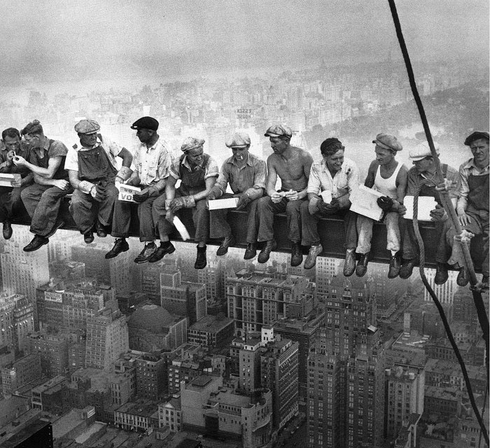 Construction Workers On Beam Eating Lunch